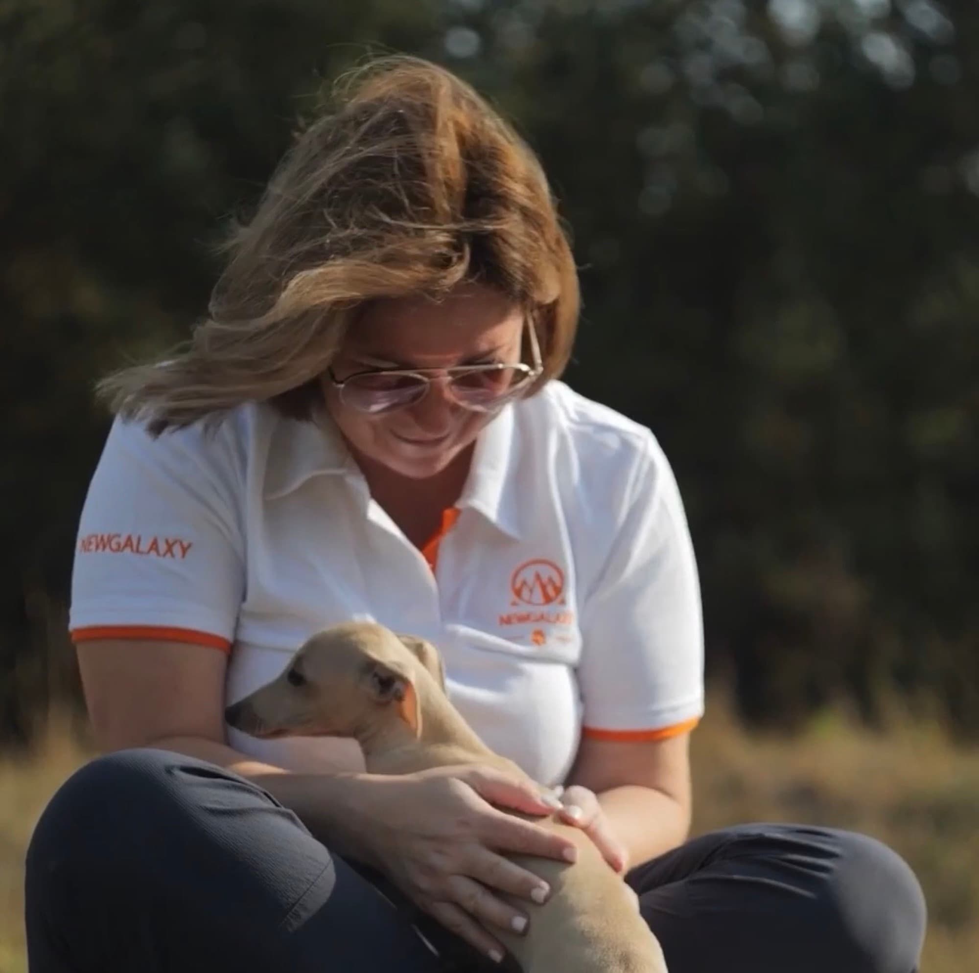 Diana Yakubovych with a whippet on her lap